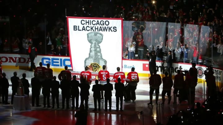Oct 7, 2015; Chicago, IL, USA; Members of the Chicago Blackhawks raise the 2015 Stanley Cup championship banner during a ceremony before the game against the New York Rangers at United Center. Mandatory Credit: Jerry Lai-USA TODAY Sports