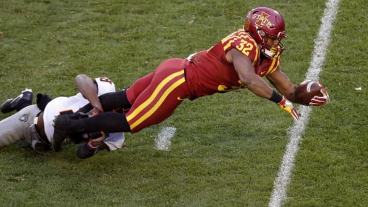 AMES, IA - NOVEMBER 11: Running back David Montgomery #32 of the Iowa State Cyclones dives into the end zone for a touchdown as cornerback Rodarius Williams #8 of the Oklahoma State Cowboys blocks in the second half of play at Jack Trice Stadium on November 11, 2017 in Ames, Iowa. The Oklahoma State Cowboys won 49-42 over the Iowa State Cyclones. (Photo by David Purdy/Getty Images)