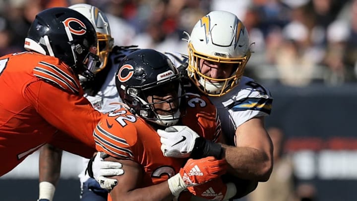 CHICAGO, ILLINOIS - OCTOBER 27: David Montgomery #32 of the Chicago Bears runs with the ball while being tackled by Joey Bosa #97 of the Los Angeles Chargers in the fourth quarter at Soldier Field on October 27, 2019 in Chicago, Illinois. (Photo by Dylan Buell/Getty Images)