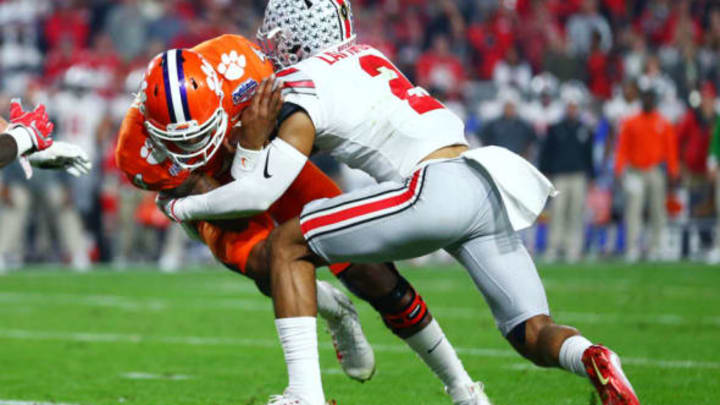 December 31, 2016; Glendale, AZ, USA; Ohio State Buckeyes cornerback Marshon Lattimore (2) tackles Clemson Tigers quarterback Deshaun Watson (4) in the 2016 CFP semifinal at University of Phoenix Stadium. Mandatory Credit: Mark J. Rebilas-USA TODAY Sports