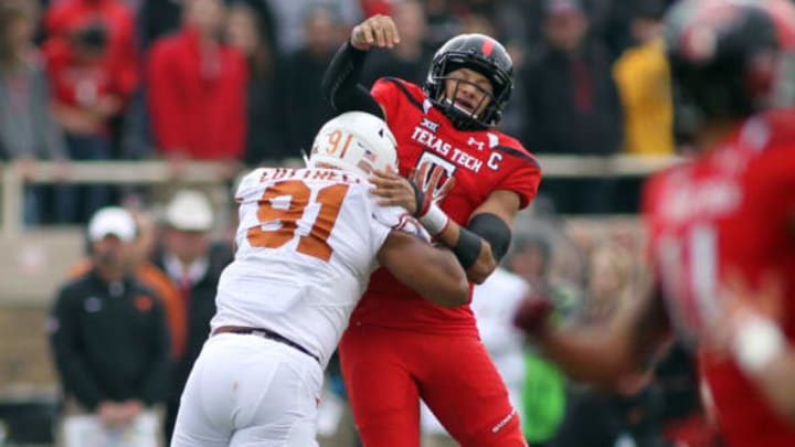 Nov 5, 2016; Lubbock, TX, USA; Texas Tech Red Raiders quarterback Patrick Mahomes (5) is hit by University of Texas Longhorns defensive lineman Bryce Cottrell (91) in the first half at Jones AT&T Stadium. Mandatory Credit: Michael C. Johnson-USA TODAY Sports