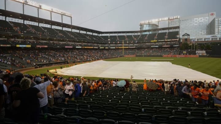 Jun 5, 2016; Baltimore, MD, USA; A general view as grounds crew pull the tarp across the field as it begin to rain during the eighth inning of the game between the Baltimore Orioles and the New York Yankees at Oriole Park at Camden Yards. Mandatory Credit: Tommy Gilligan-USA TODAY Sports