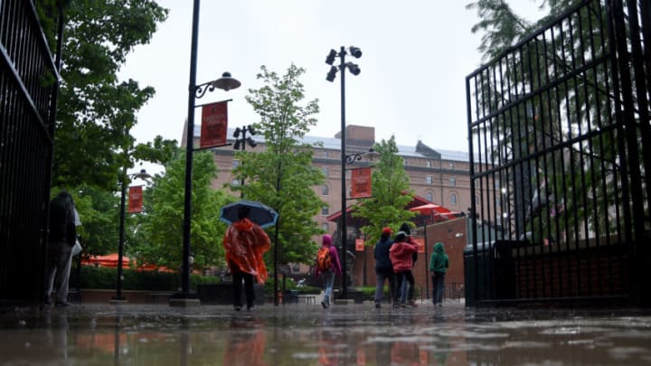 BALTIMORE, MD - MAY 12: Fans walk the concourse during a rain delay prior to the start of the game between the Baltimore Orioles and the Los Angeles Angels at Oriole Park at Camden Yards on May 12, 2019 in Baltimore, Maryland. (Photo by Will Newton/Getty Images)