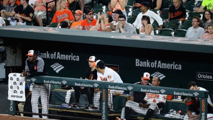 BALTIMORE, MD - JUNE 22: Members of the Baltimore Orioles look on from the dugout during the ninth inning of their 6-3 loss to the Cleveland Indians at Oriole Park at Camden Yards on June 22, 2017 in Baltimore, Maryland. (Photo by Rob Carr/Getty Images)