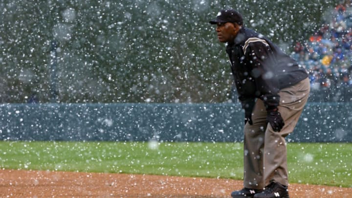 BALTIMORE - MARCH 31: Firstbase umpire Chuck Meriwether watches play through a snow squall as the Baltimore Orioles defeated the Cleveland Indians 6-5 in 13 innings in an opening day that included a 13 minute snow delay at Oriole Park at Camden Yards on March 31, 2003 in Baltimore, Maryland. (Photo by Doug Pensinger/Getty Images)