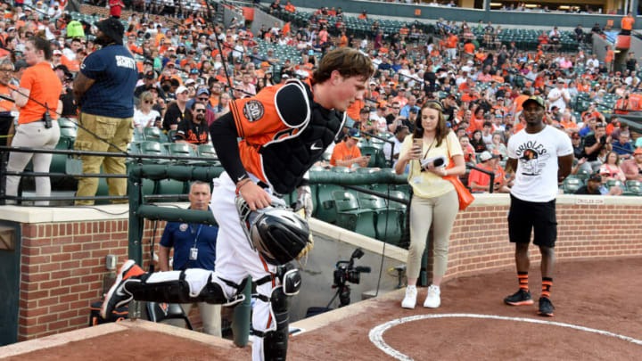 BALTIMORE, MARYLAND - MAY 21: Adley Rutschman #35 of the Baltimore Orioles takes the field in the first inning for the first time in his Major League debut against the Tampa Bay Rays at Oriole Park at Camden Yards on May 21, 2022 in Baltimore, Maryland. (Photo by G Fiume/Getty Images)