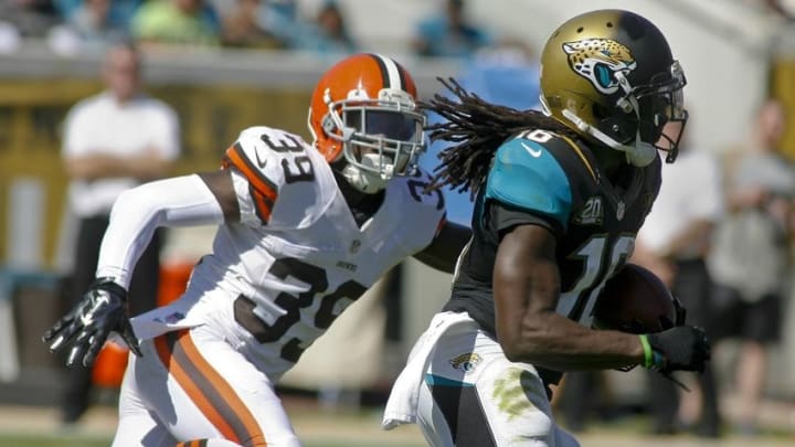 Oct 19, 2014; Jacksonville, FL, USA; Jacksonville Jaguars wide receiver Denard Robinson (16) runs past Cleveland Browns defensive back Tashaun Gipson (39) for 20-yard gain in the first quarter of their game at EverBank Field. Mandatory Credit: Phil Sears-USA TODAY Sports