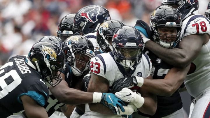 HOUSTON, TX - SEPTEMBER 15: Carlos Hyde #23 of the Houston Texans is stopped by Calais Campbell #93 of the Jacksonville Jaguars and Myles Jack #44 in the fourth quarter at NRG Stadium on September 15, 2019 in Houston, Texas. (Photo by Tim Warner/Getty Images)
