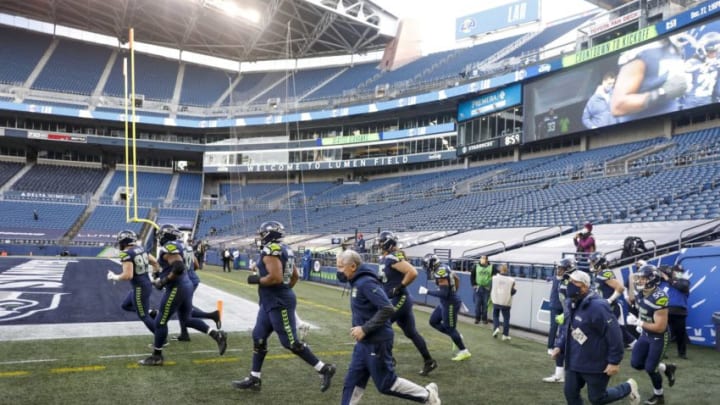 Dec 27, 2020; Seattle, Washington, USA; Seattle Seahawks head coach Pete Carroll runs out of the locker room with players and staff before kickoff against the Los Angeles Rams at Lumen Field. Mandatory Credit: Joe Nicholson-USA TODAY Sports