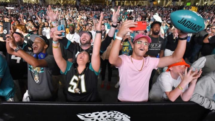 Jaguars fans celebrate as Georgia's Travon Walker. [Bob Self/Florida Times-Union]