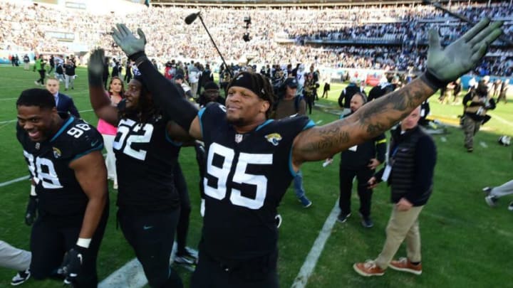 Jacksonville Jaguars defensive end Roy Robertson-Harris (95) celebrates with teammates and fans after the Jaguars overtime victory over the Cowboys. The Jacksonville Jaguars hosted the Dallas Cowboys at TIAA Bank Field Sunday, December 18, 2022. The Jaguars trailed 21 to 7 at the half but came back to win 40 to 34 with a pick six by Jacksonville Jaguars safety Rayshawn Jenkins (2) in overtime. [Bob Self/Florida Times-Union]Jki 121822 Bs Jaguars Vs Cowboys 52