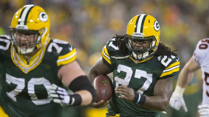 Nov 26, 2015; Green Bay, WI, USA; Green Bay Packers running back Eddie Lacy (27) rushes with the football behind guard T.J. Lang (70) during the first quarter of a NFL game against the Chicago Bears on Thanksgiving at Lambeau Field. Mandatory Credit: Jeff Hanisch-USA TODAY Sports