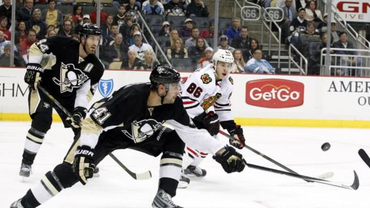 Mar 30, 2014; Pittsburgh, PA, USA; Pittsburgh Penguins defenseman Robert Bortuzzo (41) and Chicago Blackhawks left wing Teuvo Teravainen (86) chase the puck during the third period at the CONSOL Energy Center. The Pittsburgh Penguins won 4-1. Mandatory Credit: Charles LeClaire-USA TODAY Sports