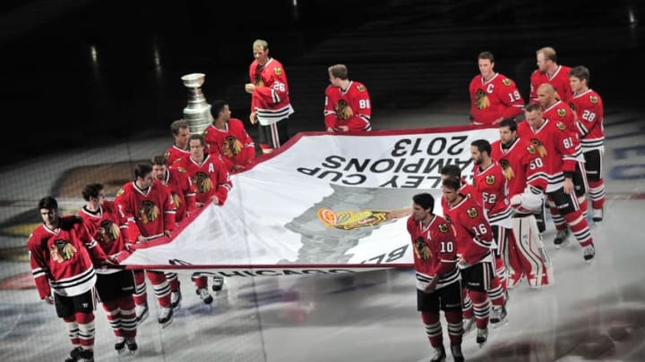 Oct 1, 2013; Chicago, IL, USA; Members of the Chicago Blackhawks skate with the 2013 Stanley Cup championship banner before the game against the Washington Capitals at the United Center. Mandatory Credit: Rob Grabowski-USA TODAY Sports