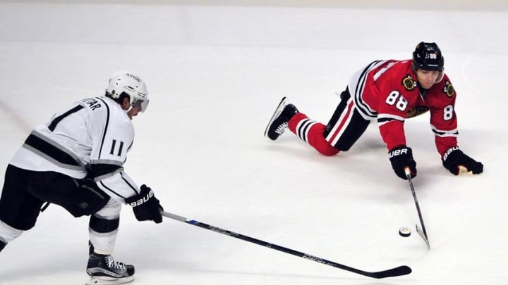 Mar 14, 2016; Chicago, IL, USA; Los Angeles Kings center Anze Kopitar (11) and Chicago Blackhawks right wing Patrick Kane (88) battle for the puck during the first period at the United Center. Mandatory Credit: David Banks-USA TODAY Sports