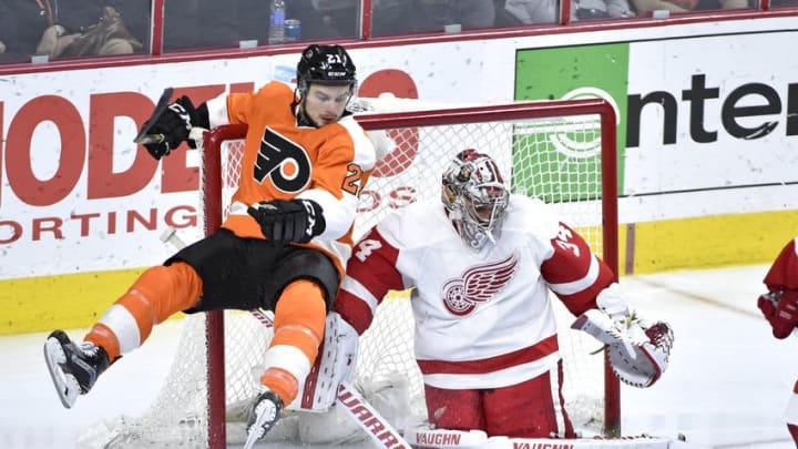 Mar 15, 2016; Philadelphia, PA, USA; Philadelphia Flyers center Scott Laughton (21) is stopped by Detroit Red Wings goalie Petr Mrazek (34) during the third period at Wells Fargo Center. The Flyers defeated the Red Wings, 4-3. Mandatory Credit: Eric Hartline-USA TODAY Sports