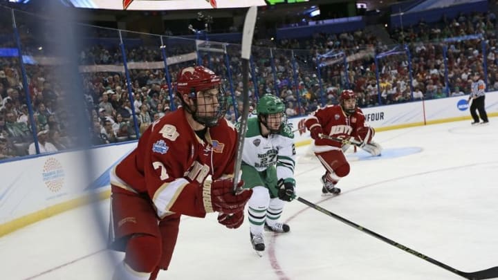 Apr 7, 2016; Tampa, FL, USA; Denver Pioneers defenseman Nick Neville (2) and North Dakota Fighting Hawks forward Luke Johnson (27) skate after the puck during the first period at the semifinals of the 2016 Frozen Four college ice hockey tournament at Amalie Arena. Mandatory Credit: Kim Klement-USA TODAY Sports