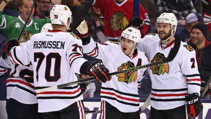 Apr 9, 2016; Columbus, OH, USA; Chicago Blackhawks right wing Patrick Kane (88) celebrates with teammates defenseman Brent Seabrook (7) and left wing Dennis Rasmussen (70) against the Columbus Blue Jackets at Nationwide Arena. The Blue Jackets won 5-4 in overtime. Mandatory Credit: Aaron Doster-USA TODAY Sports