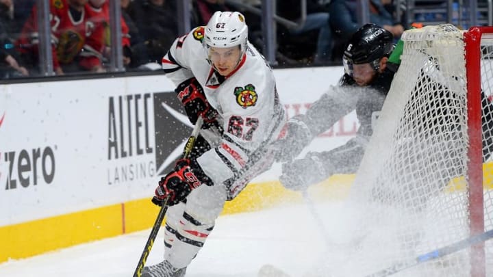 Nov 28, 2015; Los Angeles, CA, USA; Los Angeles Kings defenseman Jake Muzzin (6) and Chicago Blackhawks center Tanner Kero (67) battle for the puck in the third period of the game at Staples Center. Kings won 3-2. Mandatory Credit: Jayne Kamin-Oncea-USA TODAY Sports