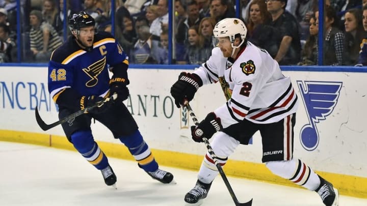 Oct 25, 2014; St. Louis, MO, USA; Chicago Blackhawks defenseman Duncan Keith (2) passes the puck under pressure from St. Louis Blues center David Backes (42) during the second period at Scottrade Center. Mandatory Credit: Jasen Vinlove-USA TODAY Sports