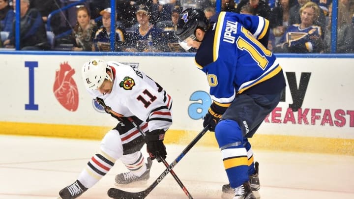 Mar 9, 2016; St. Louis, MO, USA; Chicago Blackhawks center Andrew Desjardins (11) and St. Louis Blues right wing Scottie Upshall (10) battle for the puck during the first period at Scottrade Center. Mandatory Credit: Jasen Vinlove-USA TODAY Sports
