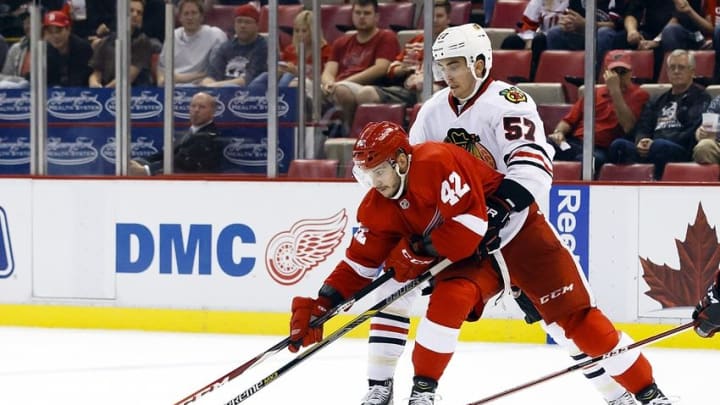 Sep 23, 2015; Detroit, MI, USA; Detroit Red Wings wing Martin Frk (42) skates with the puck defended by Chicago Blackhawks defenseman Trevor van Riemsdyk (57) in the third period at Joe Louis Arena. Detroit won 4-1. Mandatory Credit: Rick Osentoski-USA TODAY Sports