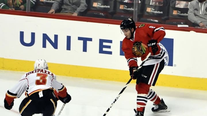 Nov 1, 2016; Chicago, IL, USA; Chicago Blackhawks center Nick Schmaltz (8) is defended by Calgary Flames defenseman Jyrki Jokipakka (3) during the first period at the United Center. Mandatory Credit: David Banks-USA TODAY Sports