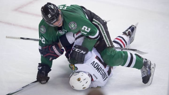 Nov 5, 2016; Dallas, TX, USA; Dallas Stars center Radek Faksa (12) takes down Chicago Blackhawks center Artem Anisimov (15) during the second period at the American Airlines Center. Mandatory Credit: Jerome Miron-USA TODAY Sports