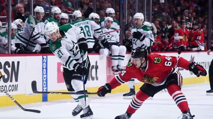 Nov 6, 2016; Chicago, IL, USA; Dallas Stars right wing Adam Cracknell (27) shoots the puck against Chicago Blackhawks left wing Tyler Motte (64) during the second period at United Center. Mandatory Credit: Mike DiNovo-USA TODAY Sports