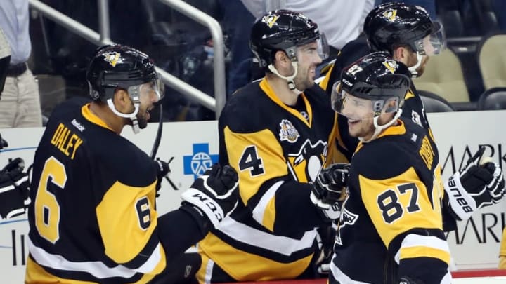 Nov 26, 2016; Pittsburgh, PA, USA; Pittsburgh Penguins center Sidney Crosby (87) celebrates with teammates on the bench after scoring a goal to tie the game against the New Jersey Devils with fourteen seconds remaining in the third period at the PPG PAINTS Arena. The Pens won 4-3 in a shootout. Mandatory Credit: Charles LeClaire-USA TODAY Sports