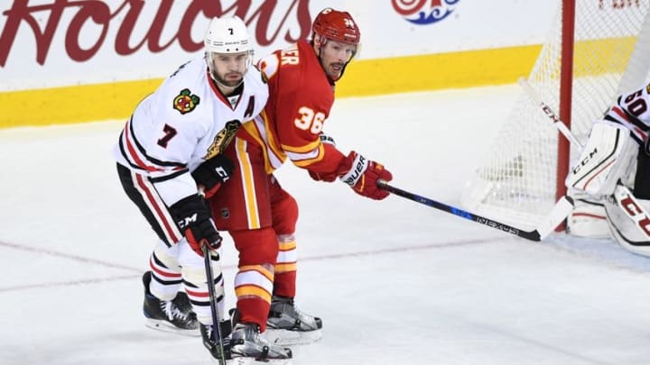 Nov 18, 2016; Calgary, Alberta, CAN; Calgary Flames right wing Troy Brouwer (36) and Chicago Blackhawks defenseman Brent Seabrook (7) collide at Scotiabank Saddledome. Blackhawks won 3-2. Mandatory Credit: Candice Ward-USA TODAY Sports