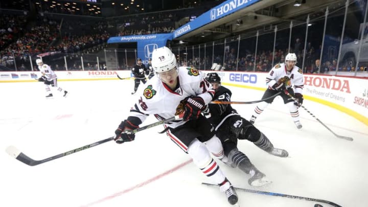 Dec 15, 2016; Brooklyn, NY, USA; Chicago Blackhawks left wing Artemi Panarin (72) and New York Islanders center Casey Cizikas (53) contend with an abandoned stick as they chase a loose puck during the second period at Barclays Center. Mandatory Credit: Brad Penner-USA TODAY Sports