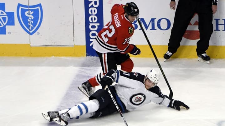 Dec 27, 2016; Chicago, IL, USA; Chicago Blackhawks left wing Artemi Panarin (72) and Winnipeg Jets center Adam Lowry (17) go for the puck during the first period at the United Center. Mandatory Credit: David Banks-USA TODAY Sports