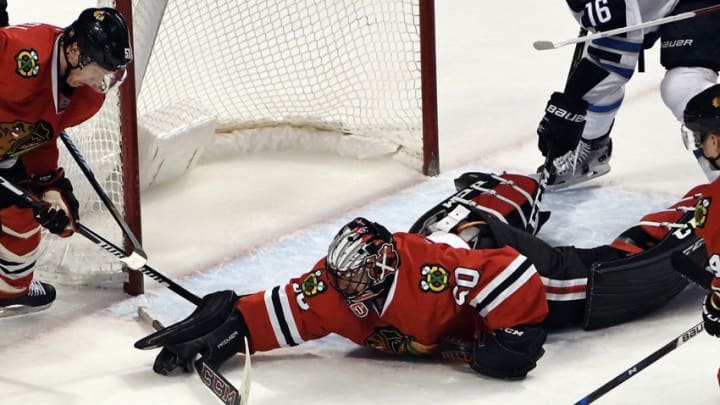 Dec 27, 2016; Chicago, IL, USA; Chicago Blackhawks goalie Corey Crawford (50) makes a diving save against the Winnipeg Jets during the second period at the United Center. Mandatory Credit: David Banks-USA TODAY Sports