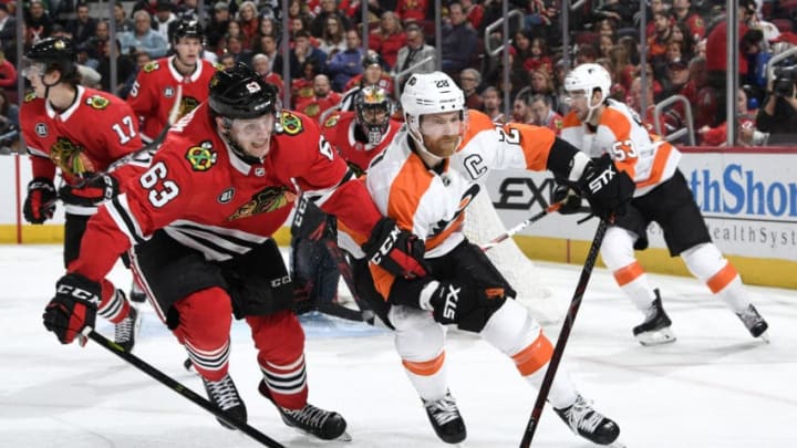 CHICAGO, IL - MARCH 21: Carl Dahlstrom #63 of the Chicago Blackhawks and Claude Giroux #28 of the Philadelphia Flyers skate in the second period at the United Center on March 21, 2019 in Chicago, Illinois. (Photo by Bill Smith/NHLI via Getty Images)