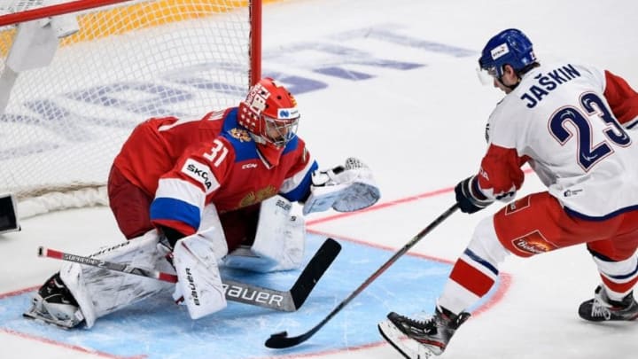 Russia's goalkeeper Ilya Sorokin (L) makes a decisive save as Czech Republic's forward Dmitrij Jaskin fails to score during the Channel One Cup of the Euro Hockey Tour ice hockey match between Russia and Czech Republic at CSKA Arena in Moscow on December 14, 2019. (Photo by Alexander NEMENOV / AFP) (Photo by ALEXANDER NEMENOV/AFP via Getty Images)