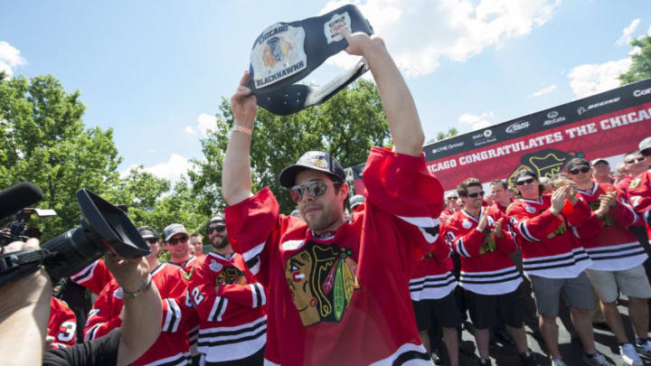 CHICAGO, IL - JUNE 28: Goalie Corey Crawford #50 of the Chicago Blackhawks holds up the teams most valuable player belt, chosen by his teammates for his performance in Game 6 of the Stanley Cup Final, during the Blackhawks Victory Parade and Rally on June 28, 2013 in Chicago, Illinois. (Photo by Bill Smith/NHLI via Getty Images)