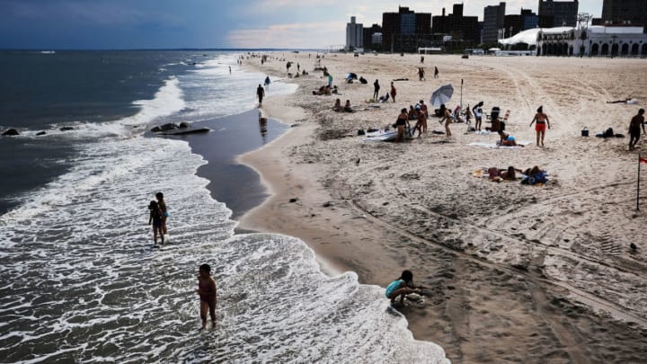 NEW YORK, NY - JUNE 21: People relax on the beach at Coney Island on the first day of summer on June 21, 2017 in New York City. Following an unseasonably wet spring, New York has been experiencing days of warm temperatures and bright sunshine. (Photo by Spencer Platt/Getty Images)