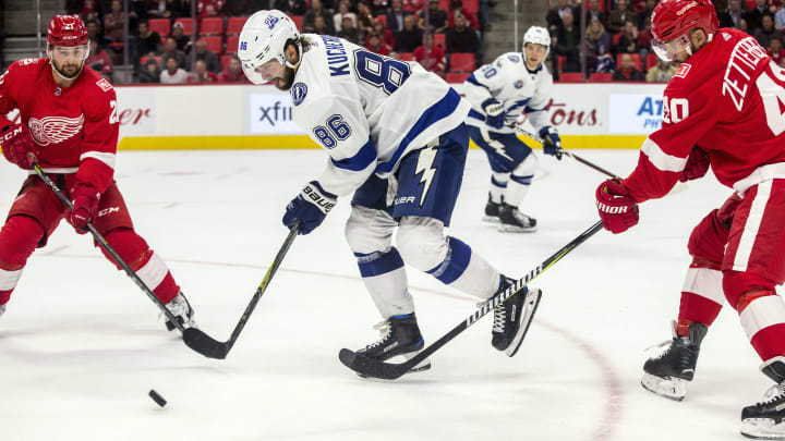 DETROIT, MI – OCTOBER 16: Tampa Bay Lightning forward Nikita Kucherov (86) controls the puck between Detroit Red Wings forward Tomas Tatar (21) and forward Henrik Zetterberg (40), in the third period of the Tampa Bay Lightning at Detroit Red Wings NHL hockey game on October 16, 2017 at Little Caesars Arena, in Detroit, MI. Tampa Bay Lightning won 3-2. (Photo by Tony Ding/Icon Sportswire via Getty Images)