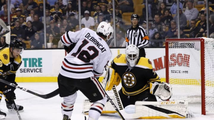 BOSTON, MA - SEPTEMBER 25: Boston Bruins goalie Malcolm Subban (70) stares down the shot from Chicago Blackhawks right wing Alex DeBrincat (12) during a preseason game between the Boston Bruins and the Chicago Blackhawks on September 25, 2017, at TD Garden in Boston, Massachusetts. (Photo by Fred Kfoury III/Icon Sportswire via Getty Images)