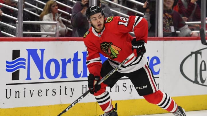 CHICAGO, IL - NOVEMBER 12: Chicago Blackhawks right wing Alex DeBrincat (12) controls the puck during the game between the New Jersey Devils and the Chicago Blackhawks on November 12, 2017 at the United Center in Chicago, Illinois. (Photo by Quinn Harris/Icon Sportswire via Getty Images)