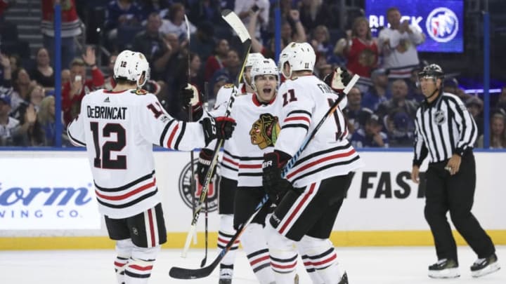 TAMPA, FL - NOVEMBER 22: Chicago Blackhawks right wing Patrick Kane (88) celebrates with teammates Cody Franson (11) and Alex DeBrincat (12) after scoring his second goal of the game in the 1st period of the NHL game between the Chicago Blackhawks and Tampa Bay Lightning on November 22, 2017 at Amalie Arena in Tampa, FL. (Photo by Mark LoMoglio/Icon Sportswire via Getty Images)