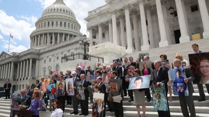 WASHINGTON, DC - JUNE 27: Senate Democrats hold photos of people who would lose their health coverage under the Senate Republicans healthcare bill, during a press conference at the U.S. Capitol on June 27, 2017 in Washington, DC. (Photo by Mark Wilson/Getty Images)