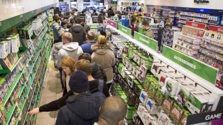 Shoppers queue to buy gaming merchandise in games retailer GAME in Westfield shopping centre in Stratford during a Black Friday event. (Photo by Rick Findler/PA Images via Getty Images)