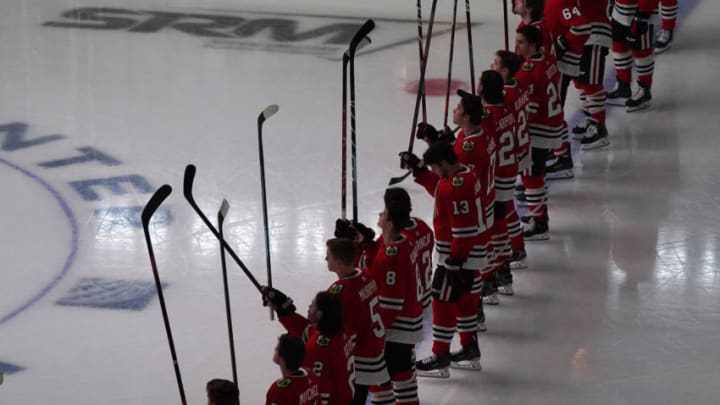 Jan 22, 2021; Chicago, Illinois, USA; The Chicago Blackhawks lift their sticks before the game against the Detroit Red Wings at the United Center. Mandatory Credit: Mike Dinovo-USA TODAY Sports