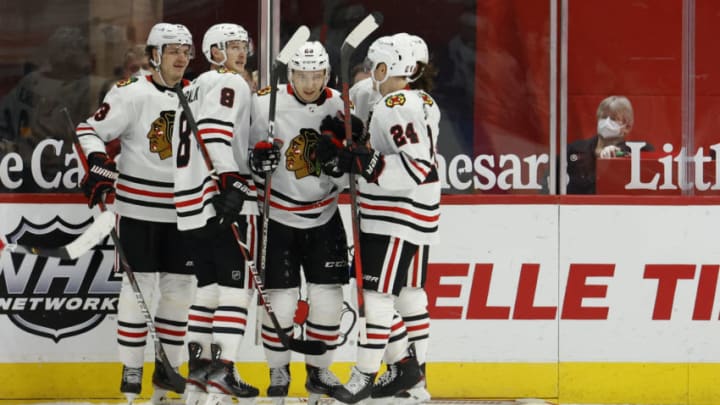 Feb 17, 2021; Detroit, Michigan, USA; Chicago Blackhawks left wing Philipp Kurashev (23) is congratulated by teammates after scoring against the Detroit Red Wings in the second period at Little Caesars Arena. Mandatory Credit: Rick Osentoski-USA TODAY Sports