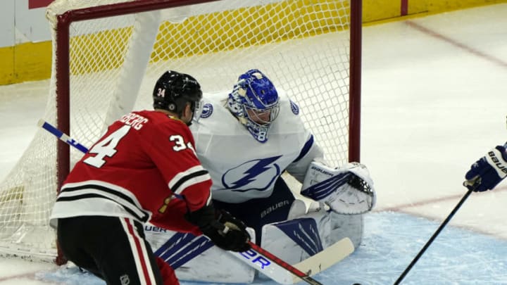 Mar 4, 2021; Chicago, Illinois, USA; Tampa Bay Lightning goaltender Andrei Vasilevskiy (88) makes a save against Chicago Blackhawks center Carl Soderberg (34) during the first period at the United Center. Mandatory Credit: Mike Dinovo-USA TODAY Sports