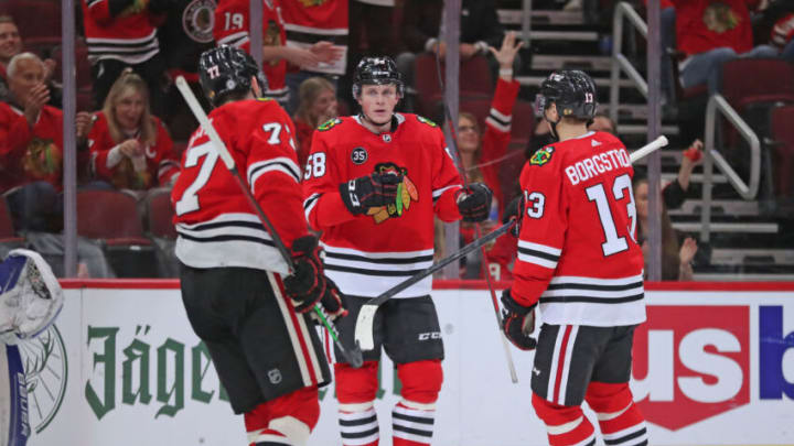 Oct 19, 2021; Chicago, Illinois, USA; Chicago Blackhawks right wing MacKenzie Entwistle (58) celebrates scoring a goal with center Kirby Dach (77) and Chicago Blackhawks left wing Henrik Borgstrom (13) during the third period against the New York Islanders at the United Center. New York won 4-1. Mandatory Credit: Dennis Wierzbicki-USA TODAY Sports