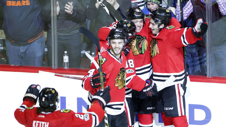 Mar 19, 2017; Chicago, IL, USA; Chicago Blackhawks defenseman Niklas Hjalmarsson (4), defenseman Duncan Keith (2) and teammates celebrate a goal during the third period of the game against the Colorado Avalanche at United Center. Mandatory Credit: Caylor Arnold-USA TODAY Sports