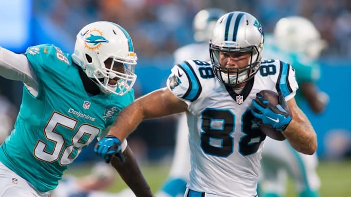 Aug 22, 2015; Charlotte, NC, USA; Carolina Panthers tight end Greg Olsen (88) runs after making a catching a pass while Miami Dolphins linebacker Chris McCain (58) pursues during the second quarter at Bank of America Stadium. Mandatory Credit: Jeremy Brevard-USA TODAY Sports